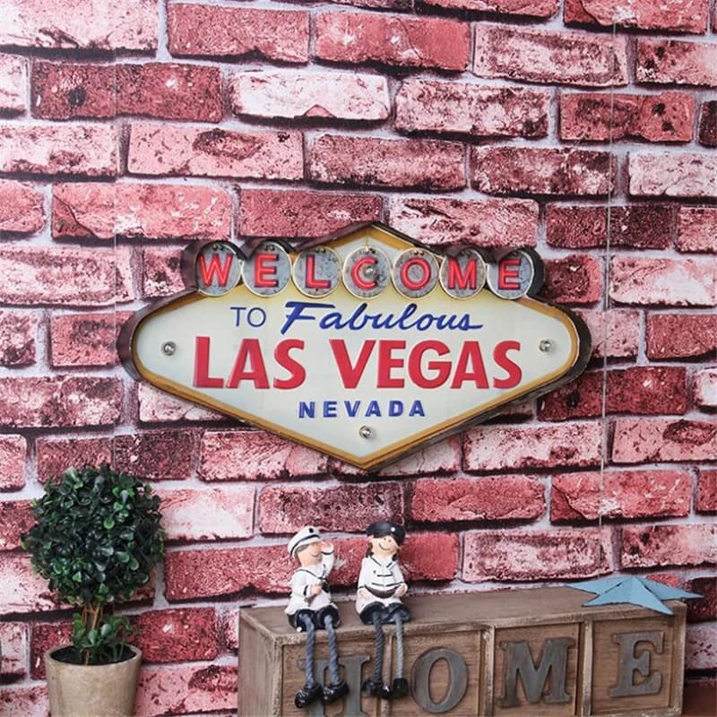 Sinal de néon vintage de Las Vegas com letras LED vermelhas e azuis, fundo branco, texto 'WELCOME TO FABULOUS LAS VEGAS NEVADA'.