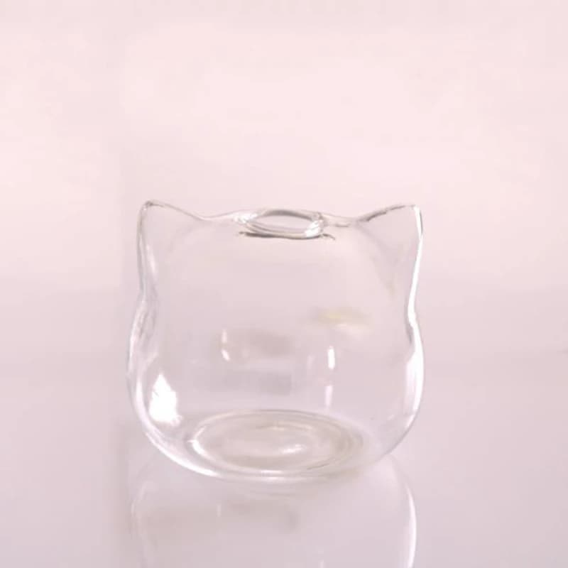 Vaso de vidro em forma de gato com flor rosa