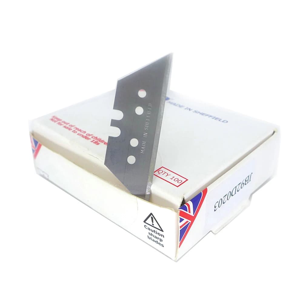 Lâmina trapezoidal para faca de corte profissional posicionada sobre caixa branca com bandeira do Reino Unido