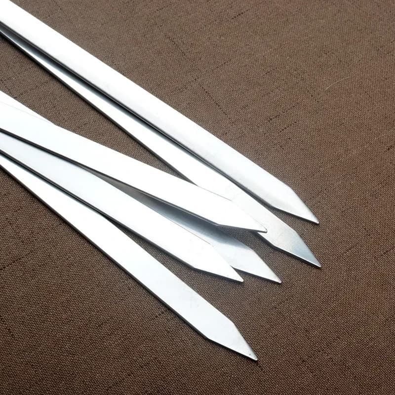 Detalhe das pontas afiadas dos espetos para churrasco em aço inoxidável prateado 55 cm