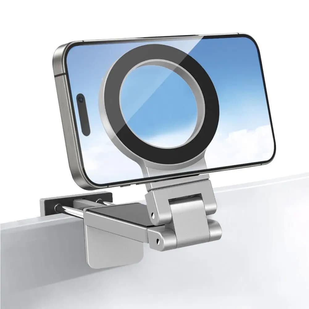 Suporte magnético para telefone em forma de avião cinza metálico fixado em superfície com iPhone 16
