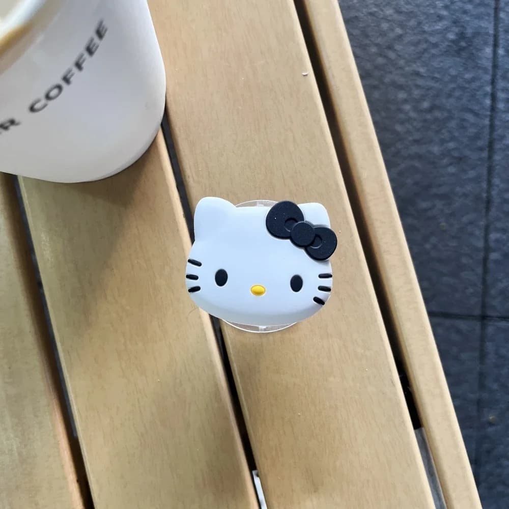 Suporte de dedo para celular Sanrio Hello Kitty branco com laço preto adesivo para smartphone