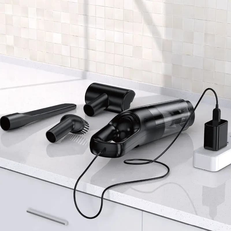 Aspirador portátil preto carregando com cabo USB e acessórios para limpeza detalhada