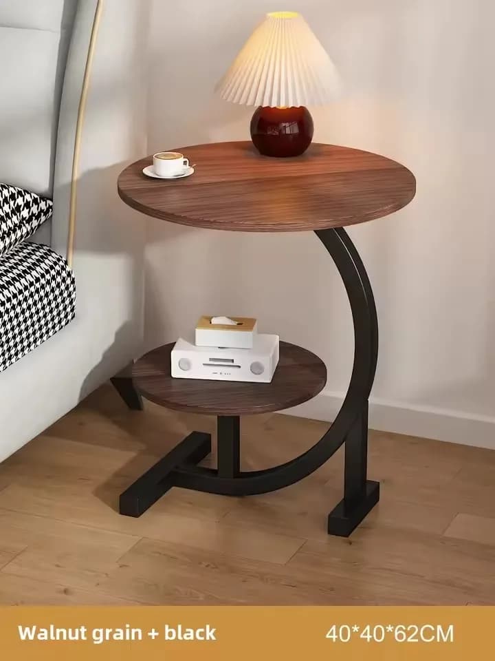 Mesa lateral redonda de mármore branco com base preta, ideal para sala de estar.