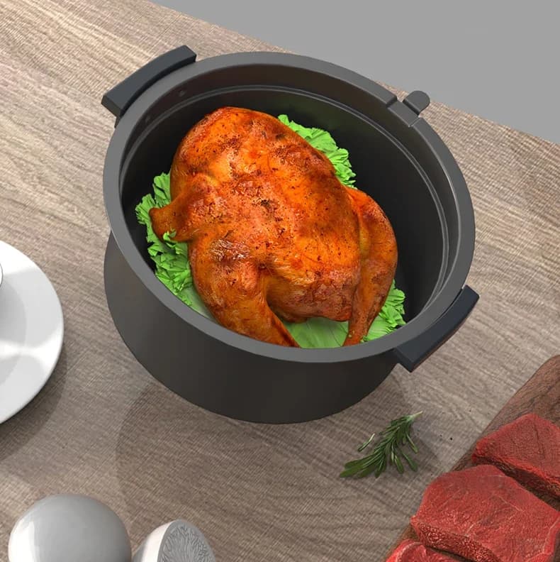 Cesto interno preto da fritadeira Oster Nuwave Digital Power Air Fryer XL com frango assado e folhas verdes