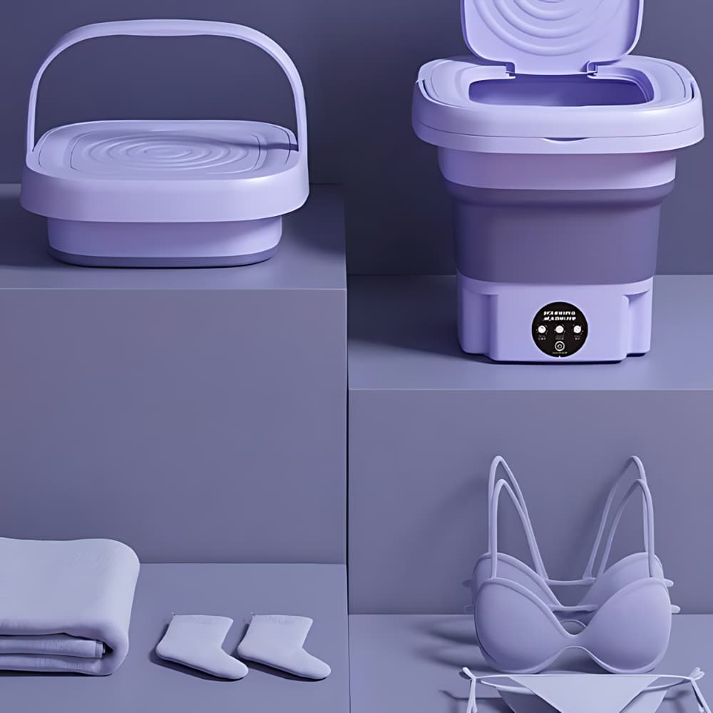 Mini máquina de lavar roupa dobrável lilás, compartimento aberto, controles, toalha e meias brancas