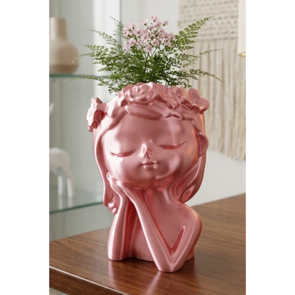 Vaso decorativo rosa em forma de mulher com flores rosa, ideal para plantas suculentas.