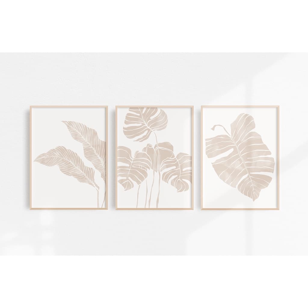 Quadros decorativos minimalistas com folhas de planta em bege sobre fundo branco