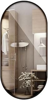 Espelho oval decorativo com borda de couro preto instalado em banheiro