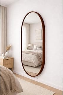 Espelho oval preto com moldura em couro para decoração de quarto ou sala.