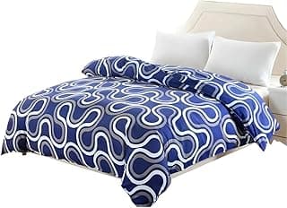 Edredom azul e branco com padrão geométrico de ondas, em uma cama com fundo branco.