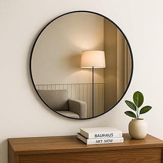 Espelho decorativo redondo 60cm com moldura preta e suporte, refletindo uma sala com cadeira e lâmpada.