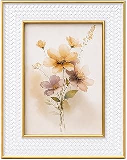 Quadro decorativo com flores em tons de amarelo e rosa, moldura branca e detalhes dourados.