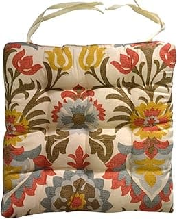 Almofada retangular com alça, estampa floral vibrante, tons de vermelho, amarelo, azul e marrom sobre fundo bege.