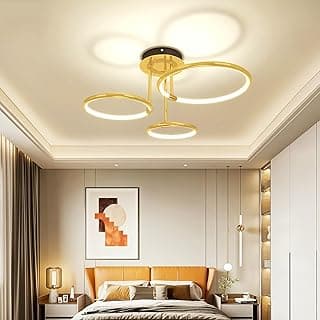 Luminária de teto LED dourada com três anéis e ajuste de temperatura de cor, em quarto decorado.