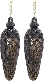 Ornamentos decorativos de pinha preta com correntes douradas, ideal para decoração de parede.