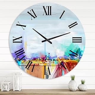 Relógio de parede grande com paisagem abstrata colorida, numerais romanos e ponteiros de relógio, fundo branco.
