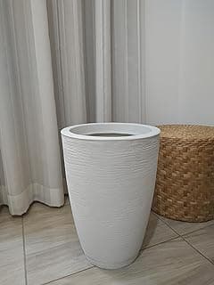 Vaso decorativo branco alto com prato, posicionado no chão de azulejos.